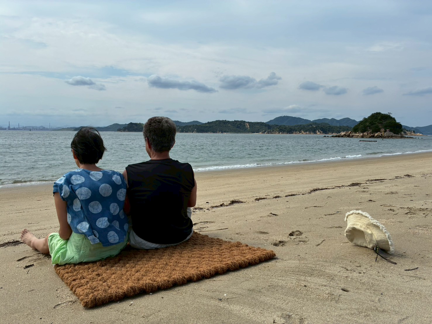 ココペーバーの上に座って海を眺める子どもたち
